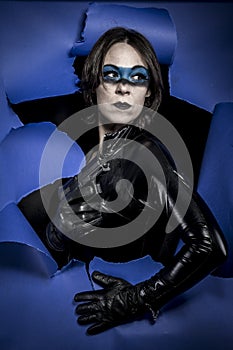 Crime, Brunette in black latex costume with pistol over broken p