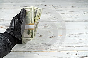 Crime Concept Man In Black Leather Gloves Holding Bricks Of Money