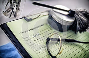 Crime lab, fingerprinting equipment next to a form