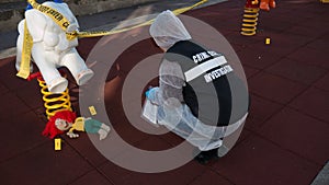 crime scene in a childrens playground, where a child was kidnapped. the police present to catalog the evidence