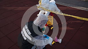 crime scene in a childrens playground, where a child was kidnapped. the police present to catalog the evidence