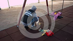 crime scene in a childrens playground, where a child was kidnapped. the police present to catalog the evidence