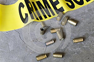 Crime scene close up of crime scene tape and brass bullet casings