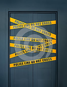 Crime scene closed door with yellow stripes text Police line do not cross