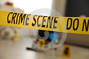 Crime scene with evidences and criminologist case, focus on yellow tape photo