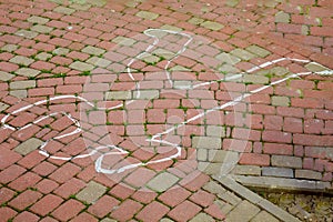 Crime scene with human body outline by chalk,drawing on the pavement.