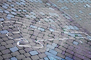 Crime scene with human body outline by chalk,drawing on the pavement.