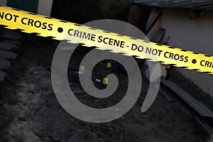 Crime scene tape for covering the area cordon. Yellow tape with blurred forensic law enforcement background in cinematic tone