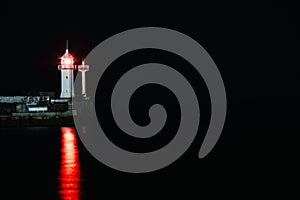 Crimea Beacon in Yalta port, lighthouse night sea background