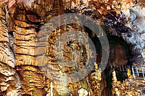 Crimea, Ukraine. Stalactites, stalagmites on the walls of the Emine-Bair-Khosar cave. Template for design. Selective sharpness