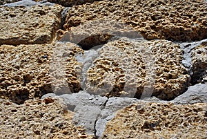 Crimean coquina rock blocks with cement wall close up texture