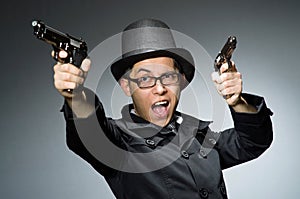 The criminal in black coat holding hadgun against