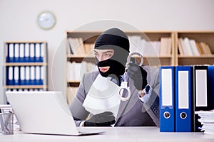 The criminal businessman with balaclava in office
