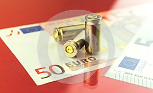 Criminal Europe and bloody dirty money concept background with bullet and Euro banknotes