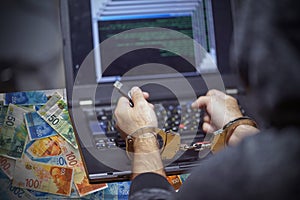 Criminal hacker hands locked in handcuffs. Closeup view