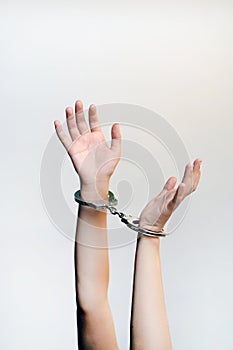 Criminal hands locked in handcuffs