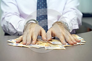 Criminal hands locked in handcuffs. Close-up hands in handcuffs