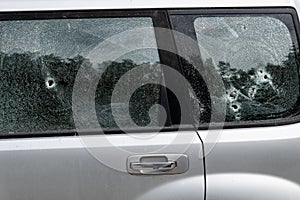 Criminal incident. Car burglary. Broken left side window of a car.