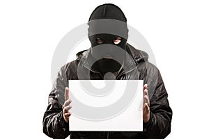 Criminal man in balaclava or mask covering face holding blank white card