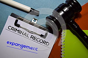 Criminal Record and Expangement text on Document form and Gavel isolated on office desk.