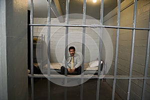 Criminal Sitting On Bed In Jail