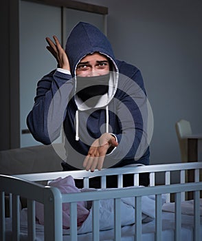 Criminal stealing baby in human child traficking concept