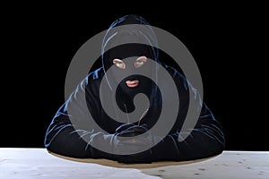 Criminal or terrorist man in mask hidden identity in secret illegal activity crime concept photo
