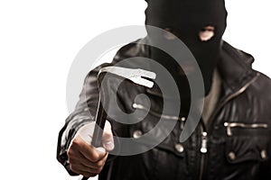 Criminal thief or burglar man in balaclava or mask holding crowbar in hand