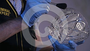 Criminologist dusting for fingerprints