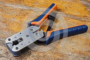 Crimping tool for mounting of the connectors RJ45 on the desktop in a workshop