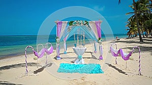 Crimson, blue Wedding arch on the Caribbean beach