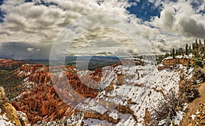 Crimson-colored hoodos under the cloudy sky in the Bryce Canyon National Park, Utah, USA