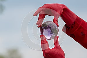 Crimson demon plays with crystal ball