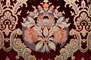 Crimson fabrics with golden pattern