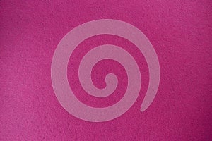 Crimson, pink felt texture background the woven fabric isolated