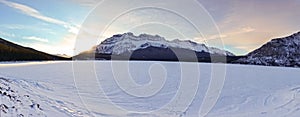 Crimson Sunset Sky over Snowcapped Mountain Peak and Frozen Lake Panoramic Landscape