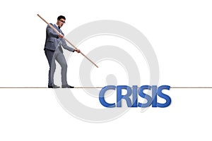 The crisis concept with businessman walking on tight rope