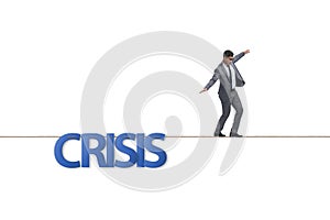 The crisis concept with businessman walking on tight rope