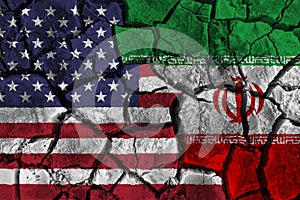 Crisis and confliction concept of america and iran . flags on cracked ground background