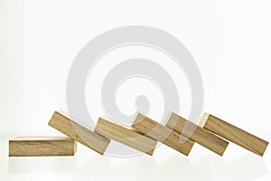 Crisis and failure in Business, Insurance and Risk Management Concept. Close up of wooden block all collapse of fall in line, with