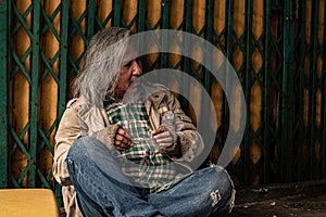 Crisis homeless aged man upset, stress no money sitting on sidewalk street, unemployed miserable street old man sad with broken