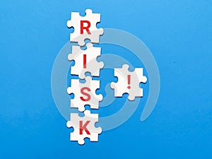 Crisis solution and problem management concept. Tetx risk on jigsaw puzzle pieces