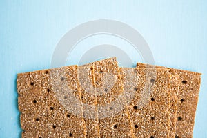 Crisp bread on the blue background. Corn dodger. Crackers. Loaf of bread