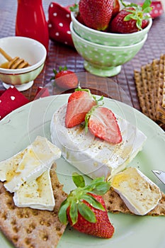Crisp bread , cheese and strawberries