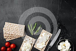 Crisp bread sandwich, on black dark stone table background, top view flat lay, with copy space for text