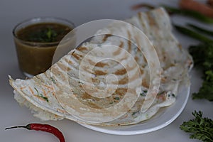 Crisp carrot onion dosa served with a bowl of sambar