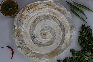 Crisp carrot onion dosa served with a bowl of sambar