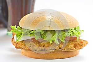 Crisp chicken burger tomato onion cheese lettuce