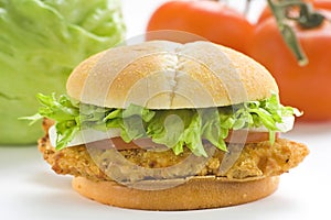 Crisp chicken burger tomato onion cheese lettuce