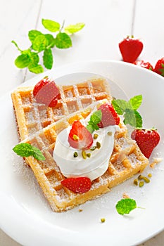 Crisp golden waffles, strawberries and cream